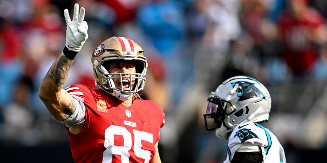 George Kittle, #85 of the San Francisco 49ers, celebrates a play during the first half in the game against the Carolina Panthers at Bank of America Stadium on Oct. 9, 2022 in Charlotte, North Carolina.