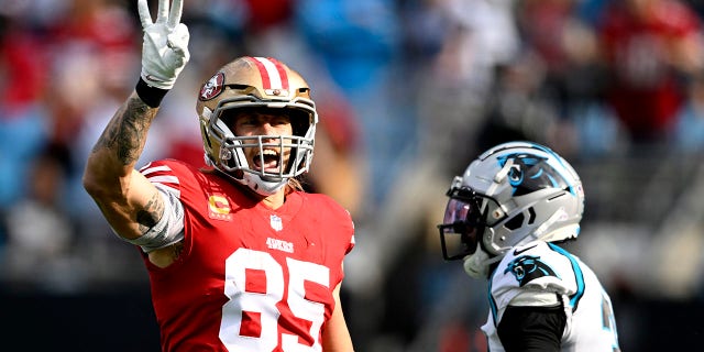 George Kittle, #85 of the San Francisco 49ers, celebrates a play during the first half in the game against the Carolina Panthers at Bank of America Stadium on Oct. 9, 2022 in Charlotte, North Carolina.