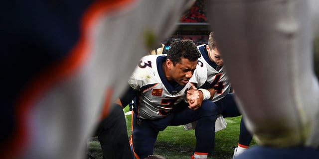 Russell Wilson of the Broncos leads a prayer following Denver's victory over the Jacksonville Jaguars at Wembley Stadium on Oct. 30, 2022, in London.