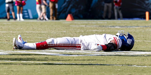 Linebacker Kayvon Thibodeaux, #5 of the New York Giants, celebrates a win by laying on his back on the field and pretend to make a snow angel after defeating the Jacksonville Jaguars at TIAA Bank Field on Oct. 23, 2022 in Jacksonville, Florida.