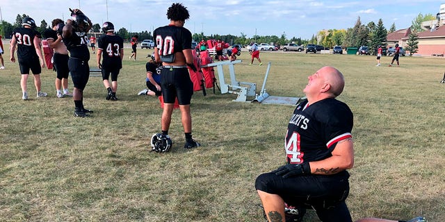 Ray Ruschel, a 49-year-old freshman football player for the North Dakota State College of Science, takes his turn on the blocking sled Sept. 20, 2022, in Wahpeton, N.D. 