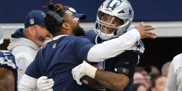 Dallas Cowboys' Ezekiel Elliott congratulates Micah Parsons after his touchdown run against the Chicago Bears Sunday, Oct. 30, 2022, in Arlington, Texas.