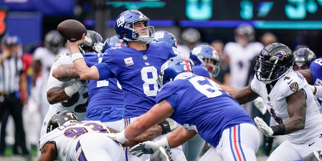 New York Giants quarterback Daniel Jones (8) throws a pass as Baltimore Ravens' Calais Campbell (93) pressures him during the first half of an NFL football game Sunday, Oct. 16, 2022, in East Rutherford, N.J.