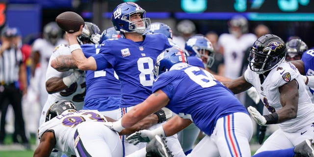 New York Giants quarterback Daniel Jones (8) throws a pass as Baltimore Ravens' Calais Campbell (93) pressures him during the first half of an NFL football game Sunday, Oct. 16, 2022, in East Rutherford, N.J.
