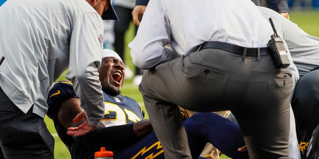 Los Angeles Chargers cornerback J.C. Jackson, #27, screams out in pain after injuring himself on a play late in the first half against the Seattle Seahawks at SoFi Stadium.