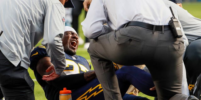 Los Angeles Chargers cornerback J.C. Jackson, #27, screams out in pain after injuring himself on a play late in the first half against the Seattle Seahawks at SoFi Stadium.