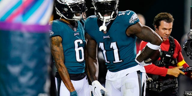 Philadelphia Eagles' A.J. Brown, right, and Philadelphia Eagles' DeVonta Smith celebrate Brown's touchdown during the first half of an NFL football game against the Dallas Cowboys on Sunday, Oct. 16, 2022, in Philadelphia. 