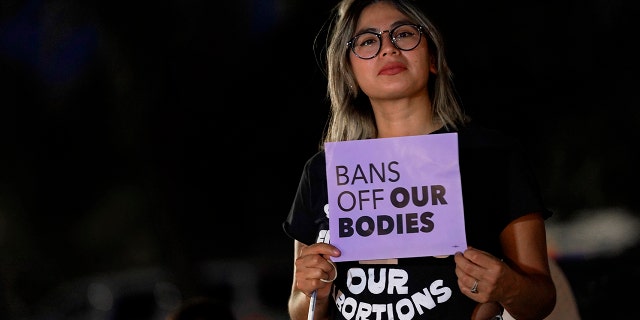 Celina Washburn protests outside the Arizona Capitol to voice her dissent with an abortion ruling, Friday, Sept. 23, 2022, in Phoenix. 