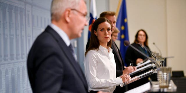 Finland's Prime Minister Sanna Marin looks at Finland's Foreign Minister Pekka Haavisto as he speaks during a press conference by the Government of Finland in Helsinki, Finland, on Sept. 28, 2022.