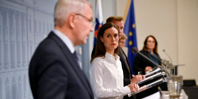 Finland's Prime Minister Sanna Marin looks at Finland's Foreign Minister Pekka Haavisto as he speaks during a press conference by the Government of Finland in Helsinki, Finland, Wednesday Sept. 28, 2022.