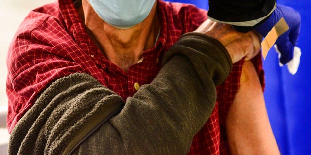 FILE - A man receives a flu shot in Brattleboro, Vt., on Tuesday, Oct. 26, 2021. Doctors have a message for vaccine-weary Americans: Don't skip your flu shot this fall 2022. And for the first time, seniors are urged to get a special extra-strength kind. 