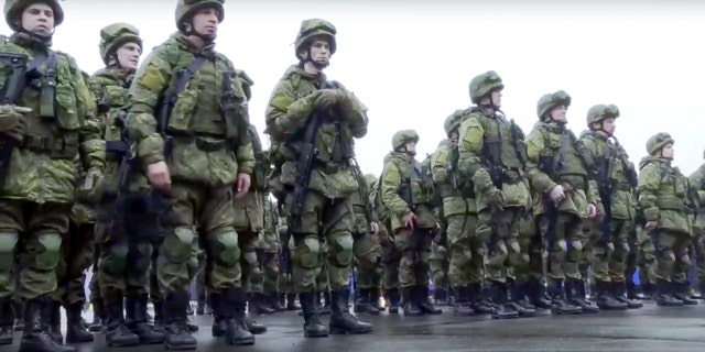 In this handout photo taken from video released by Russian Defense Ministry Press Service, Russian recruiters stand prior to their military training at the Patriot Park outside in Moscow, Russia, Saturday, Oct. 1, 2022. Russian President Vladimir Putin has ordered a partial mobilization of reservists to beef up his forces in Ukraine. (Russian Defense Ministry Press Service via AP)