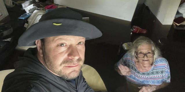 Johnny Lauder takes a selfie with his mother, Karen Lauder, 86, as he came to rescue her after water flooded her home, in Naples, Fla., Wednesday, Sept. 28, 2022, following Hurricane Ian.