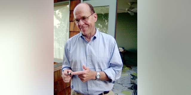 K. Barry Sharpless points to a sample used in his work, as he stands on the balcony outside of his home office in La Jolla, Calif. on Oct. 10, 2001.