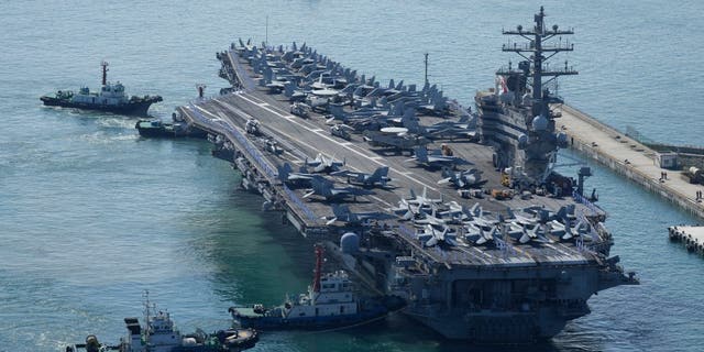 FILE - The U.S. carrier USS Ronald Reagan is escorted as it arrives in Busan, South Korea on Sept. 23, 2022. North Korea launched two short-range ballistic missiles toward its eastern waters Thursday, Oct. 6, 2022. 