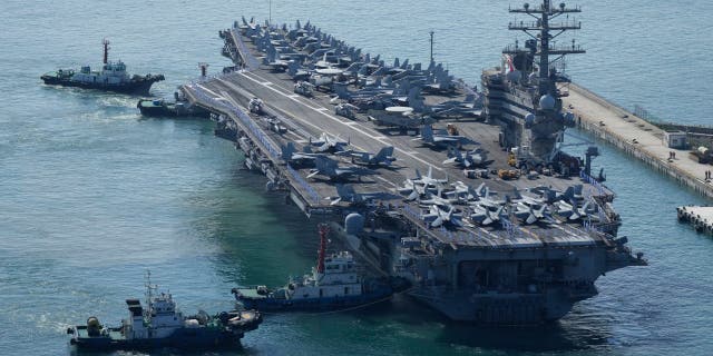 FILE - The U.S. carrier USS Ronald Reagan is escorted as it arrives in Busan, South Korea on Sept. 23, 2022. North Korea launched two short-range ballistic missiles toward its eastern waters Thursday, Oct. 6, 2022.