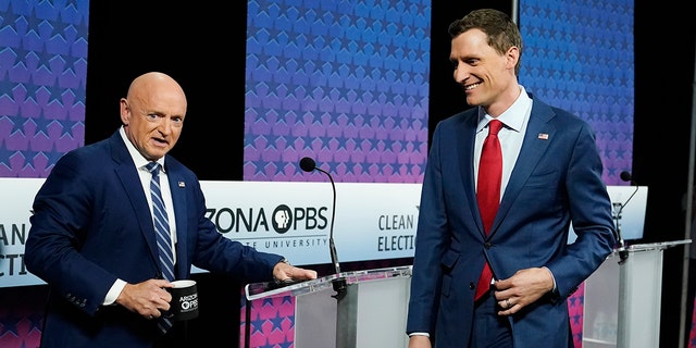 Arizona Democratic Sen. Mark Kelly and his Republican challenger Blake Masters arrive for a televised debate in Phoenix, Oct. 6, 2022.