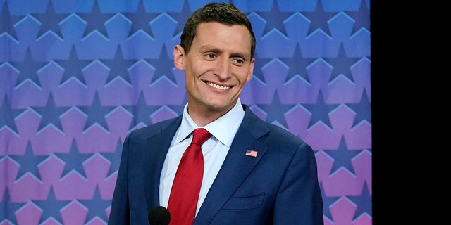 Republican Arizona Senate nominee Blake Masters smiles on stage prior to a televised debate with Arizona Democratic Sen. Mark Kelly and Libertarian candidate Marc Victor in Phoenix, Thursday, Oct. 6, 2022.
