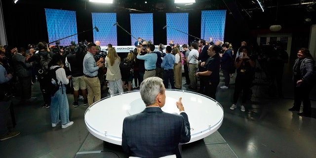 "Arizona Horizon" host and managing editor Ted Simons sits on the set as members of the media cover Arizona Democratic Sen. Mark Kelly, Republican candidate Blake Masters, and Libertarian candidate Marc Victor prior to a televised debate in Phoenix, Thursday, Oct. 6, 2022. 