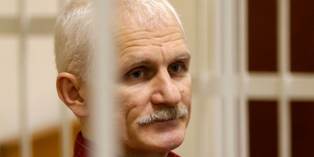 Ales Bialiatski, the head of Belarusian Vyasna rights group, stands in a defendants' cage during a court session in Minsk, Belarus, on Wednesday, Nov. 2, 2011.
