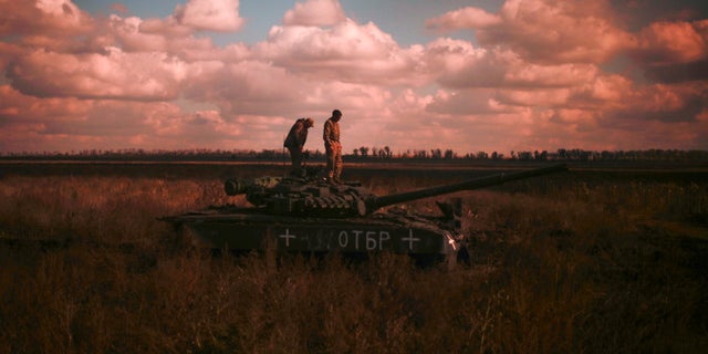 Ukrainian servicemen stand on top a Ukrainian tank near the recently retaken village of Borova, east Ukraine, Friday, Oct. 7, 2022.