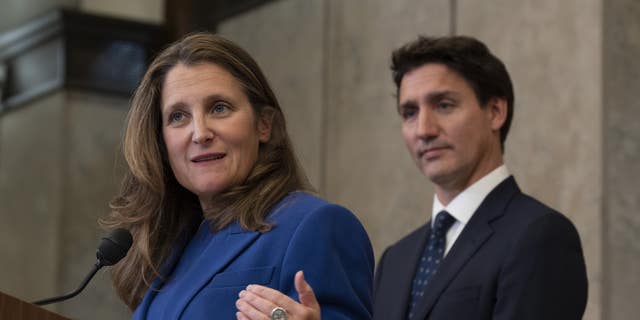 Canadian Prime Minister Justin Trudeau looks on as Deputy Prime Minister and Finance Minister Chrystia Freeland speaks after announcing sanctions on Iran, in Ottawa, Friday, Oct. 7, 2022. 