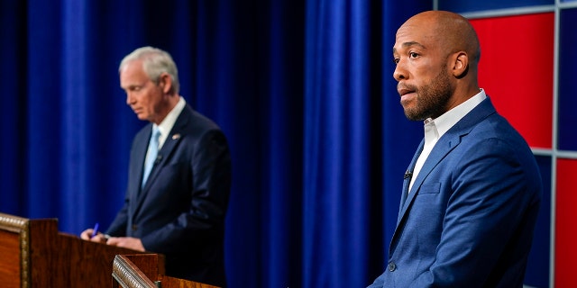 U.S. Sen. Ron Johnson, R-Wis., left, and his Democratic challenger Mandela Barnes wait for start of a televised debate, Friday, Oct. 7, 2022, in Milwaukee. 