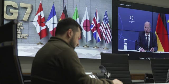 In this image from video provided by the Ukrainian Presidential Press Office, Ukrainian President Volodymyr Zelenskyy, left, and German Chancellor Olaf Scholz, right on the screen, attend the video conference of the leaders of the Group of Seven and Ukraine, in Kyiv, Ukraine, Tuesday, Oct. 11, 2022. 