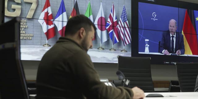 In this image from video provided by the Ukrainian Presidential Press Office, Ukrainian President Volodymyr Zelenskyy, left, and German Chancellor Olaf Scholz, right on the screen, attend the video conference of the leaders of the Group of Seven and Ukraine, in Kyiv, Ukraine, Tuesday, Oct. 11, 2022. 