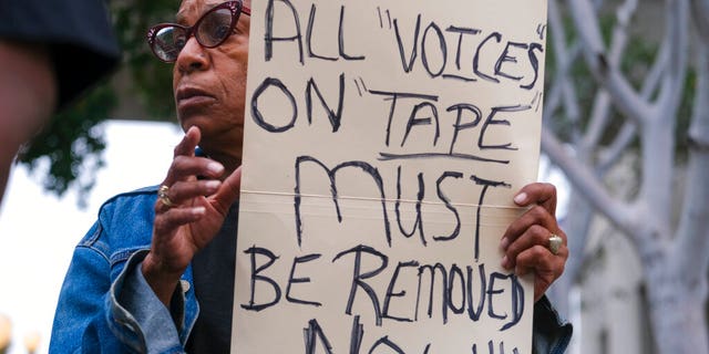 Veronica Sance holds a sign at a news conference to denounce racism and demand change in response to a recorded, racially charged leaked conversation between leaders at City Hall and the Los Angeles County. On Wednesday, the council committee censured council members Kevin de Leon, Gil Cedillo and former member Nury Martinez.