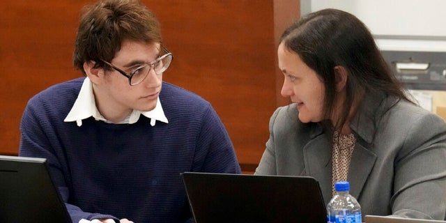 Marjory Stoneman Douglas High School shooter Nikolas Cruz speaks with sentence mitigation specialist Kate O'Shea, a member of the defense team, during jury instructions in the penalty phase of Cruz's trial at the Broward County Courthouse in Fort Lauderdale, Fla. on Wednesday, Oct. 12, 2022.