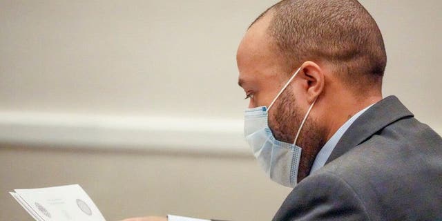 Darrell Brooks looks over documents during his trial at the Waukesha County Circuit Court in Waukesha, Wisconsin, on Wednesday, Oct. 12, 2022. Prosecutors allege Brooks, 40, killed six people and injured scores of others on Nov. 21.