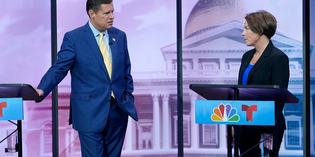 Massachusetts Republican Geoff Diehl, left, speaks with Massachusetts Democratic Attorney General Maura Healey, right, before their televised debate for governor, Wednesday, Oct. 12, 2022, at NBC10 Boston television studios, in Needham, Mass. 