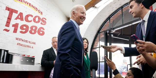 President Joe Biden answers questions at Tacos 1986, a Mexican restaurant, after ordering takeout in Los Angeles on Thursday, October 13, 2022. 