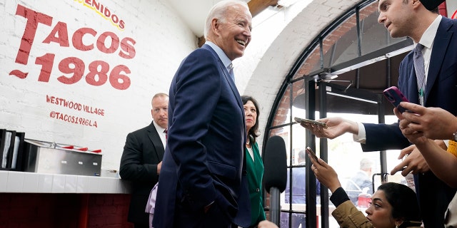 President Joe Biden answers questions at Tacos 1986, a Mexican restaurant, after ordering take out in Los Angeles, Thursday, Oct. 13, 2022. 