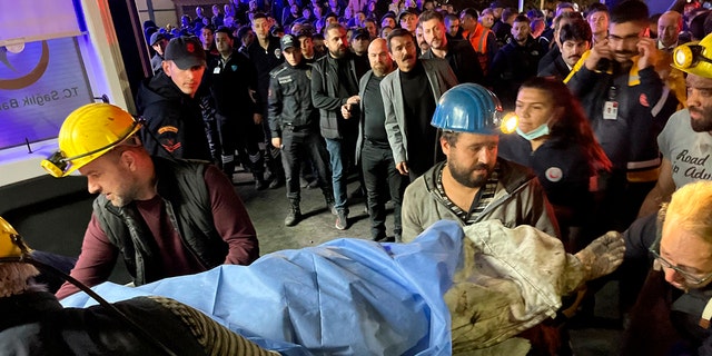 Miners transport the body of a victim to Amasra, in the coastal province of Bartin, Turkey, on the Black Sea on Friday, October 14, 2022. 