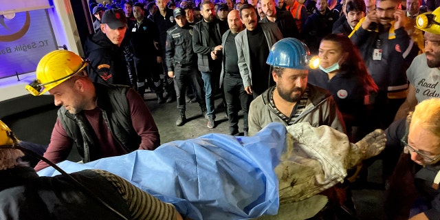 Miners transport the body of a victim to Amasra, in the coastal province of Bartin, Turkey, on the Black Sea on Friday, October 14, 2022. 