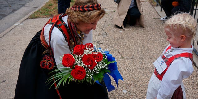 Eline Gro Knatterud, 4, greets Queen Sonja of Norway as she arrives to Den Norske Lutherske Mindekirke, the Norwegian Lutheran Memorial Church in Minneapolis, Sunday Oct. 16, 2022.