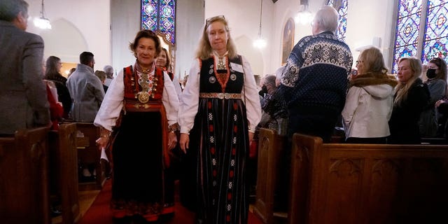 Jeannette Henrikssen, president of the church council, right and Queen Sonja of Norway walk out of Den Norske Lutherske Mindekirke, the Norwegian Lutheran Memorial Church in Minneapolis, Sunday Oct. 16, 2022.