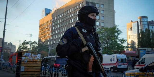 Police block the perimeter at the scene of Russian shelling in Kyiv, Ukraine, Monday, Oct. 17, 2022, after some explosions rocked Kyiv in the early morning.