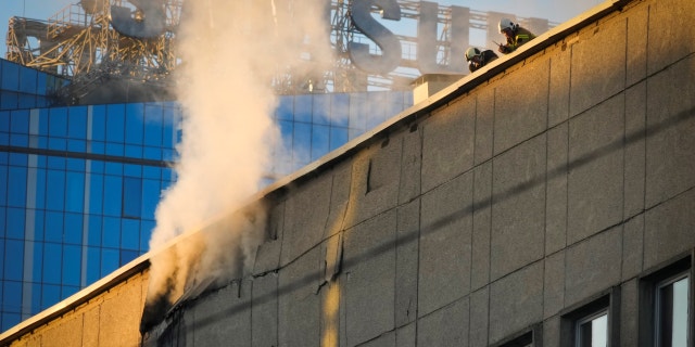 Firefighters work at the scene of Russian shelling in Kyiv, Ukraine, Monday, Oct. 17, 2022, amid apparent airstrikes from Russians.