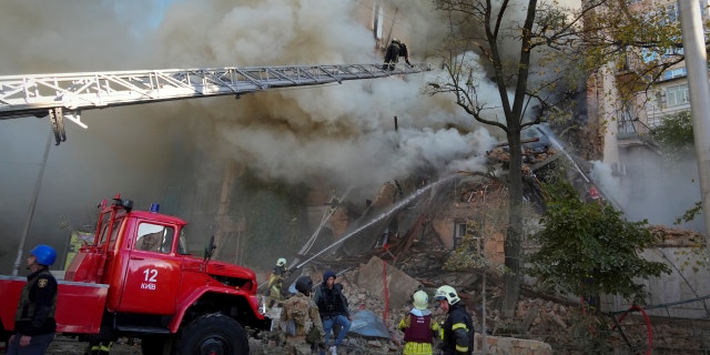 Firefighters on site after a drone severely damaged buildings in Kiev, Ukraine on Monday, October 17, 2022.