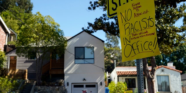 A sign condemning Los Angeles City Council member Kevin de León is posted across the street from his home in Los Angeles, Tuesday, Oct. 18, 2022.