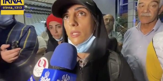 In this image taken from video by Iran's state-run IRNA news agency, Iranian competitive climber Elnaz Rekabi speaks to journalists in Imam Khomeini International Airport in Tehran, Iran, Wednesday, Oct. 19, 2022. 