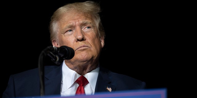 FILE - Former President Donald Trump pauses while speaking at a rally at the Minden Tahoe Airport in Minden, Nevada, on Oct. 8, 2022.