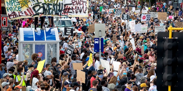 FILE - Protesters gather calling for justice for George Floyd on May 26, 2020, in Minneapolis. 