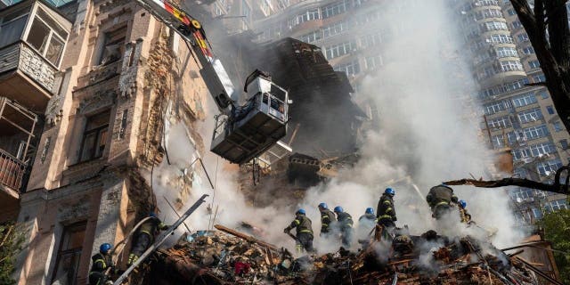 FILE - Firefighters work after a drone attack on buildings in Kyiv, Ukraine, Oct. 17, 2022.