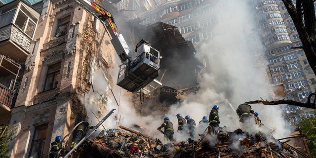 Firefighters work after a drone attack on buildings in Kiev, Ukraine, Oct.17, 2022. 