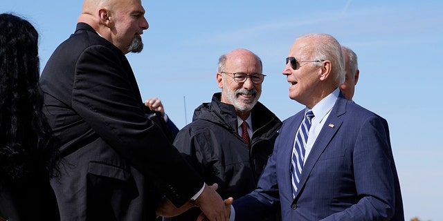 President Biden speaks with Pennsylvania Lt. Gov. John Fetterman, a Democratic candidate for U.S. Senate, after stepping off Air Force One, Thursday, Oct. 20, 2022.