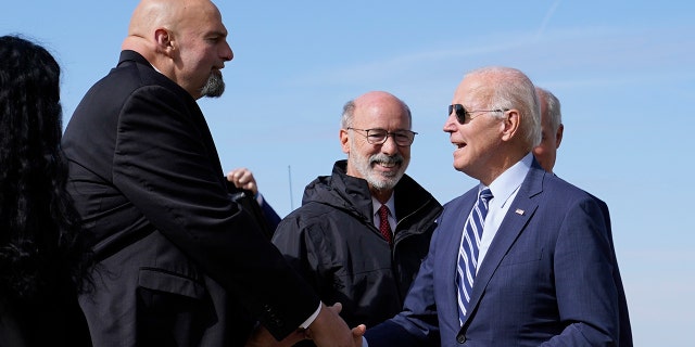 President Biden speaks with Pennsylvania Lt. Gov. John Fetterman, the Democratic candidate for the U.S. Senate, after exiting Air Force One on Thursday, Oct. 20, 2022.